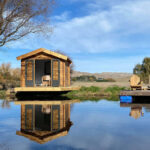 outside of star cabin sitting room with a deck on a lake