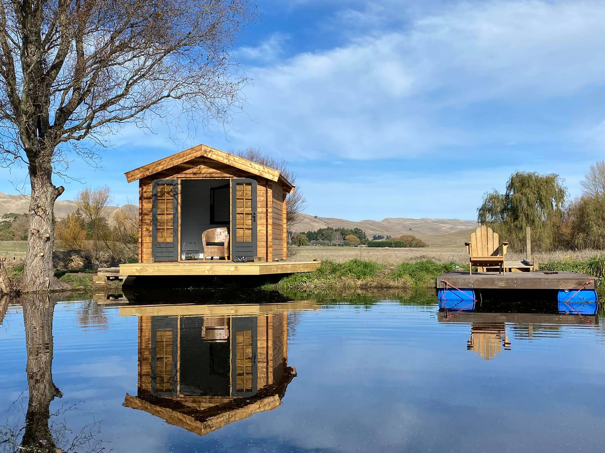 outside of star cabin sitting room with a deck on a lake