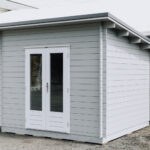 outside of painted star summit display cabin home office with french doors
