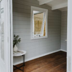inside of painted star summit display cabin home office with open window
