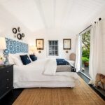 inside of star deluxe sleepout cabin with casement window and open doors