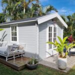 outside of painted cabana cabin backyard retreat with side deck and casement window and french doors