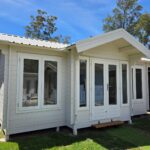 outside of painted display brook river cabin with colourbond roof