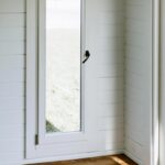 inside of unfurnished tussock display cabin with tilt and turn window closeup