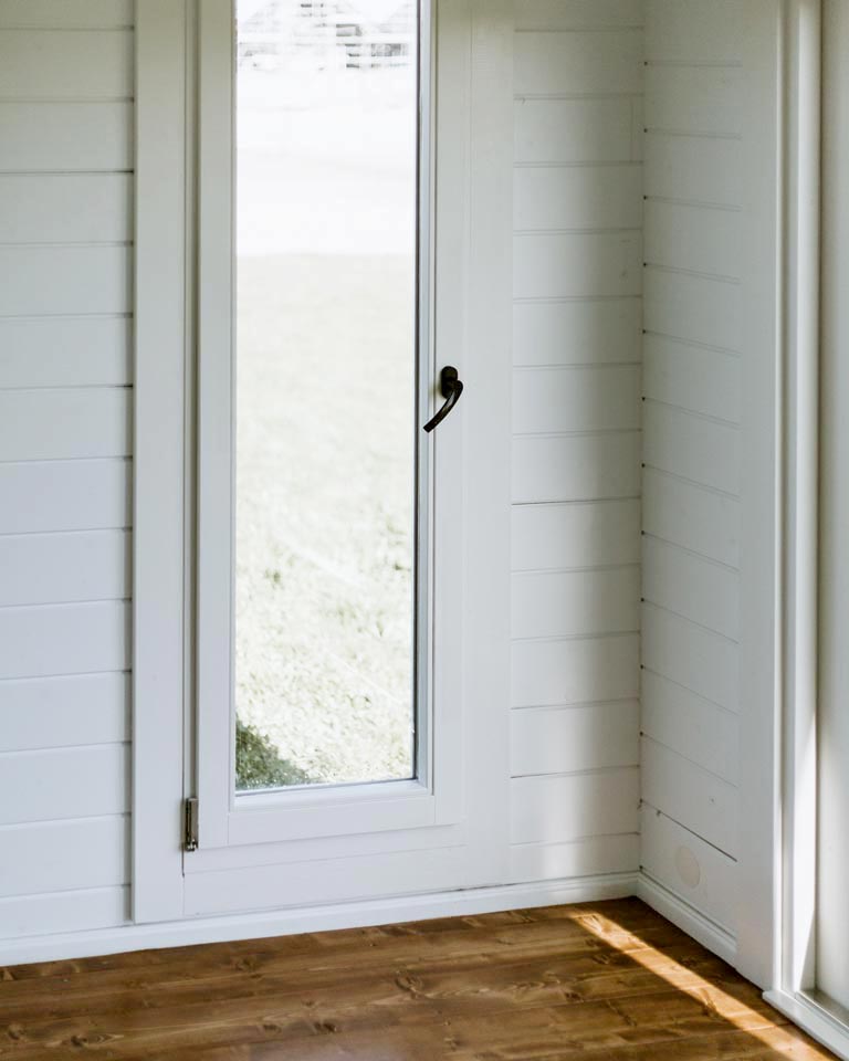 inside of unfurnished tussock display cabin with tilt and turn window closeup