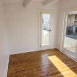 inside of unfurnished tussock display cabin with tilt and turn window and floorboards