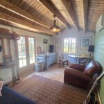 inside of woodland cabin used as backyard retreat with open casement window