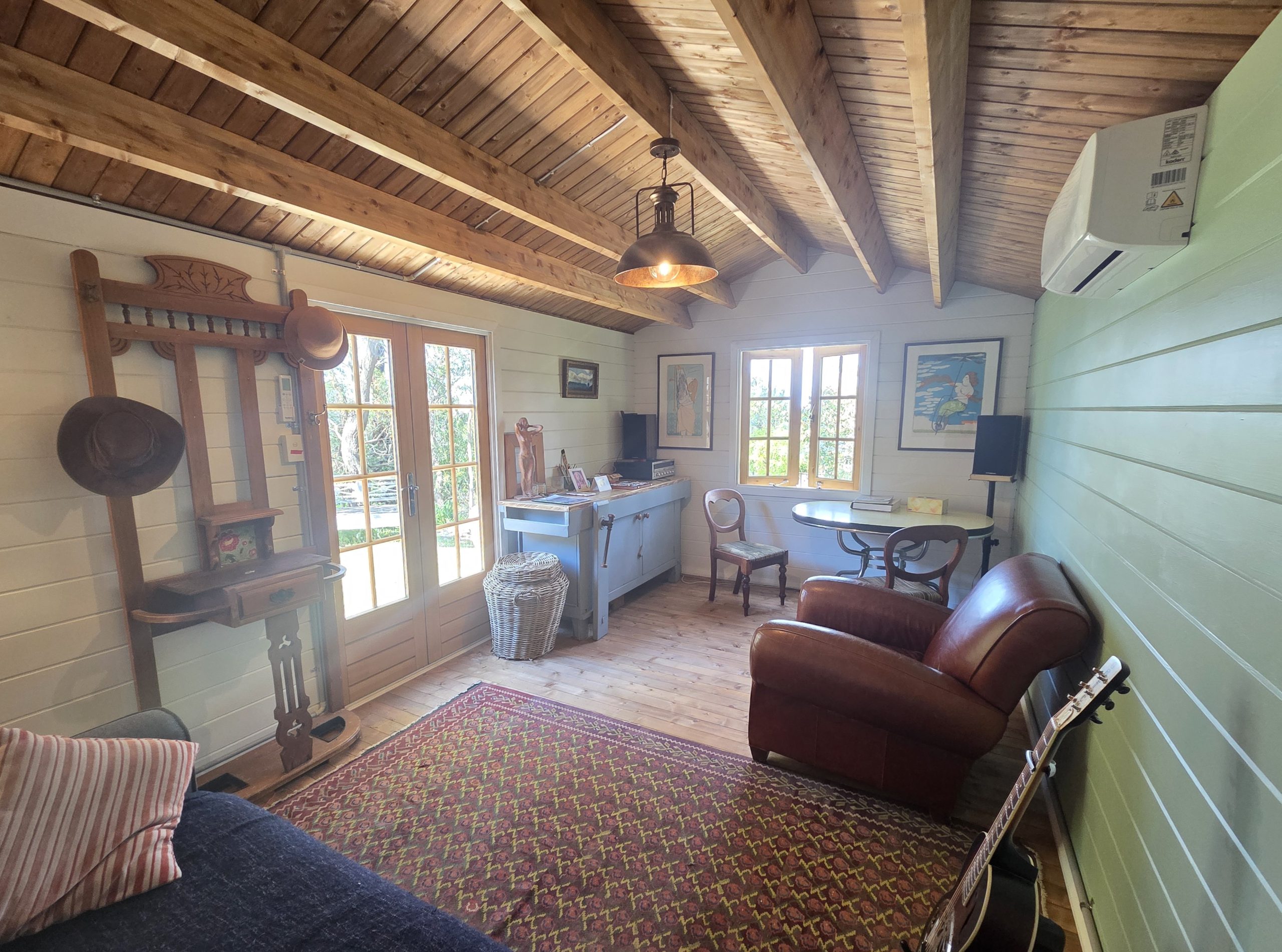 inside of woodland cabin used as backyard retreat with open casement window