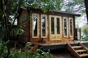 log cabin on a raised deck with steps