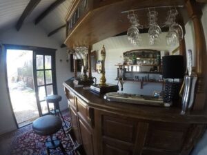 Bar cabin display with glasses in a outdoor man cave