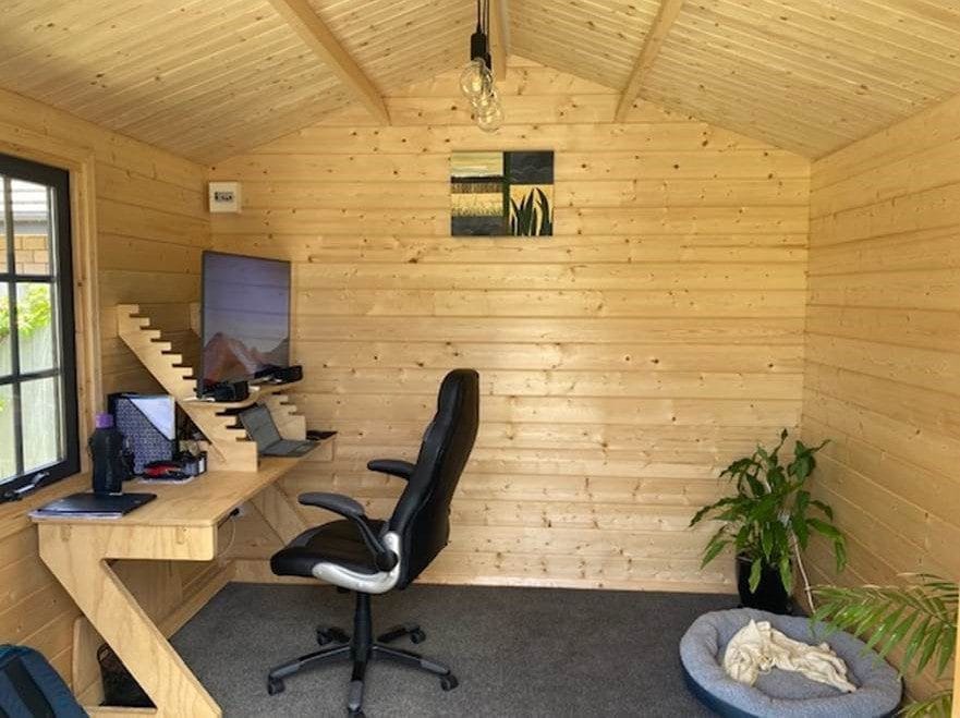 Home office set up with a timber sit stand desk in a cabin